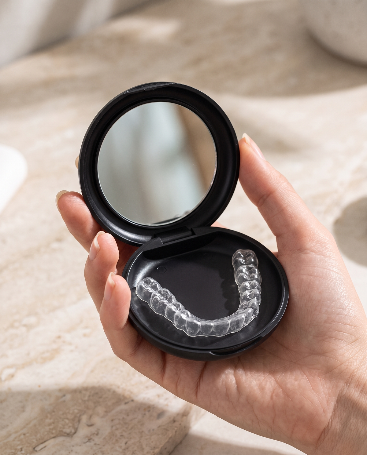 Open pocket case holding a clear retainer