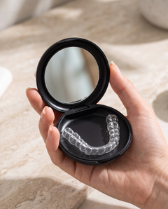 Open pocket case holding a clear retainer