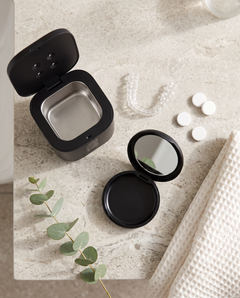 Pod, pocket case, retainer and tablets on a counter