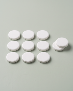 Round white cleaning tablets